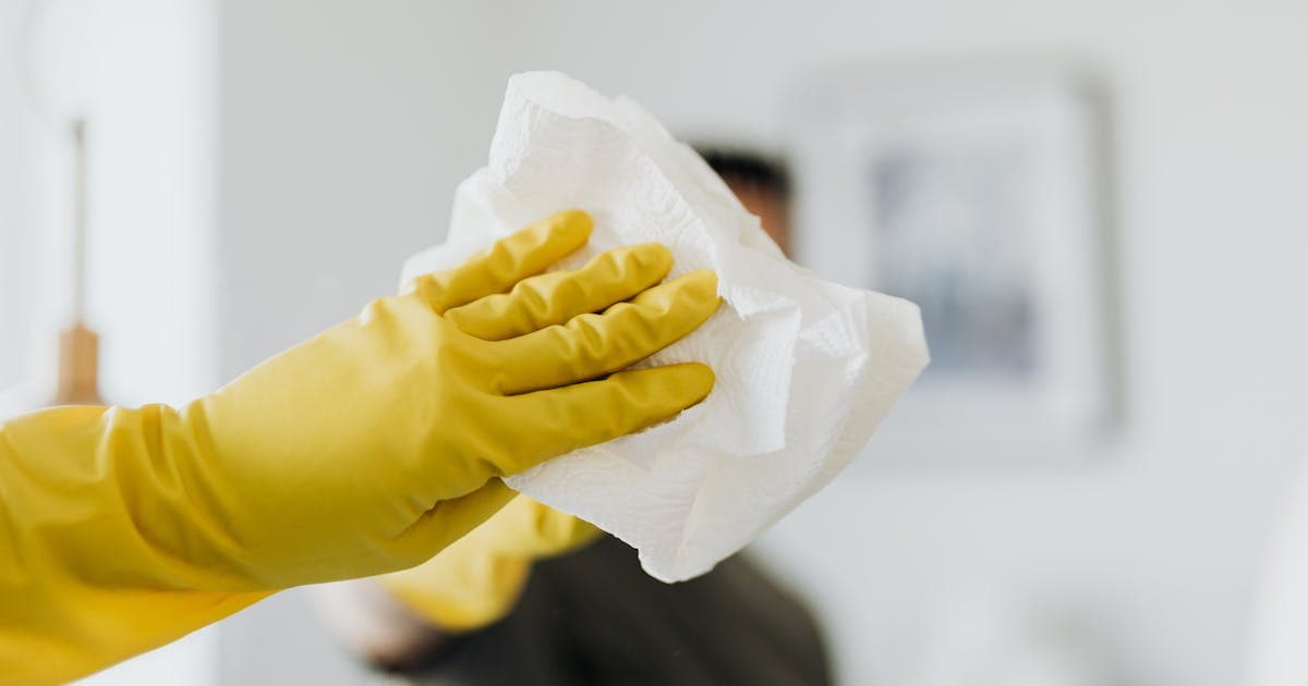 Professional auto detailer polishing a luxury vehicle