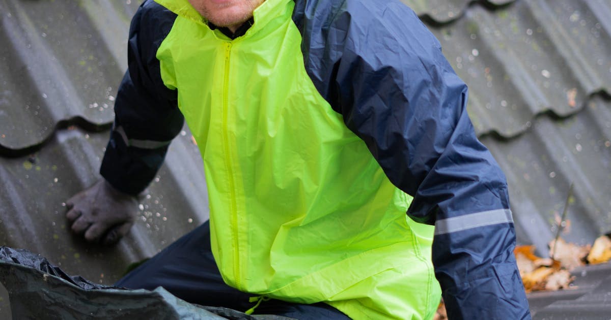 Roofing contractors working on a residential roof